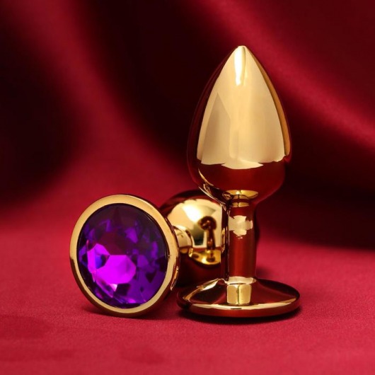 Золотистая анальная пробка с фиолетовым кристаллом - Сима-Ленд - купить с доставкой в Екатеринбурге